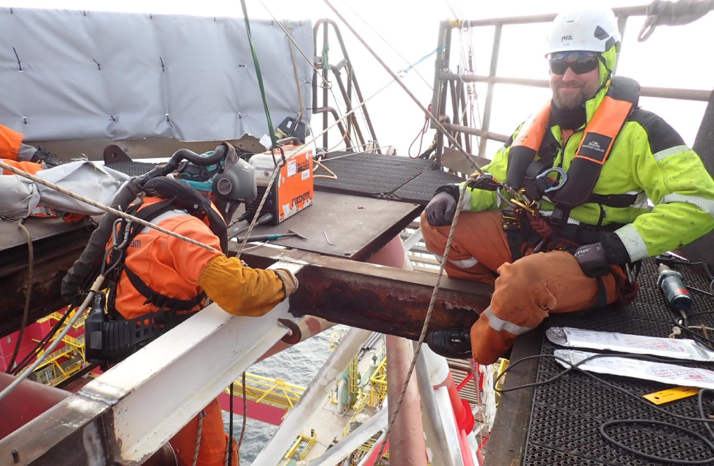 Coded welders on ropes command serious day rates — the combination is rare and in constant demand Rope access welding crew on an offshore platform